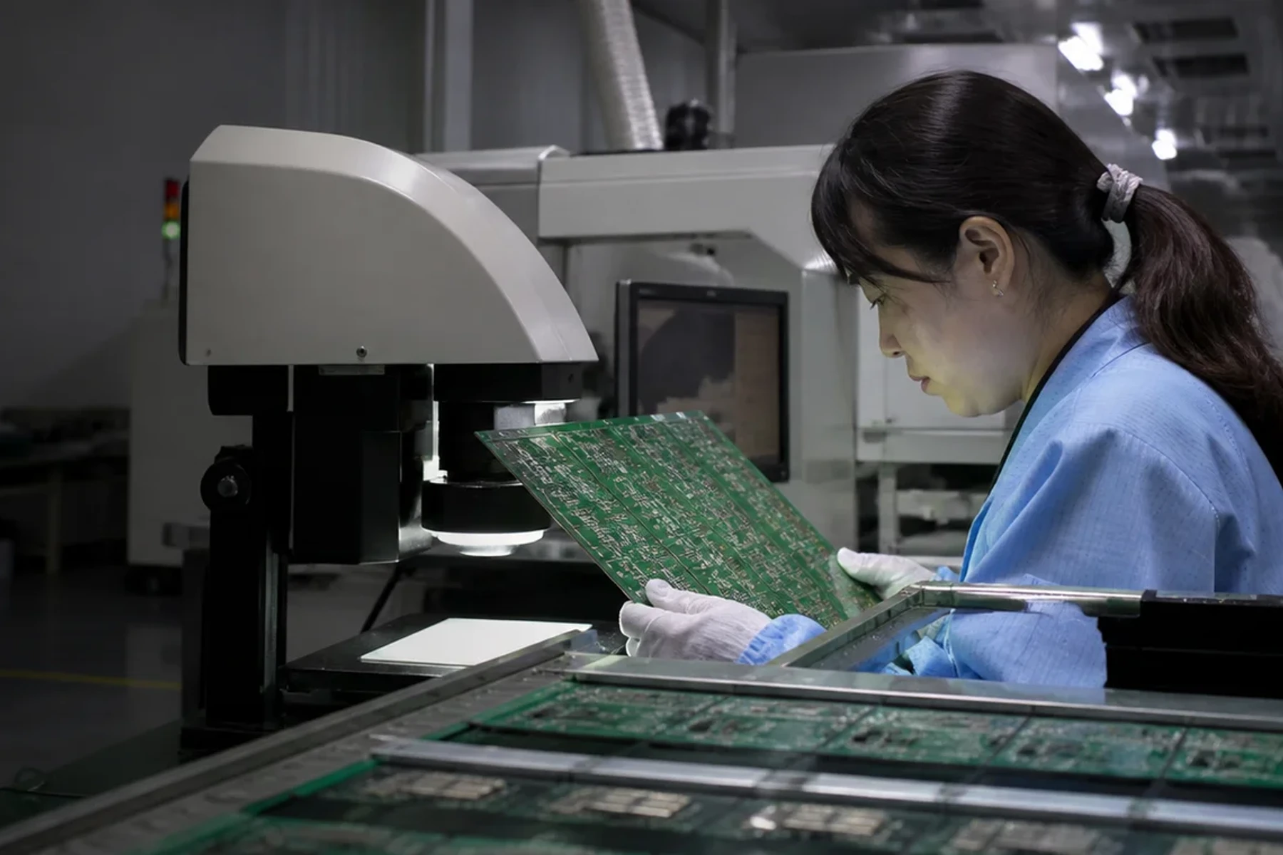 PCB manufacturing workbench with circuit boards and inspection tools